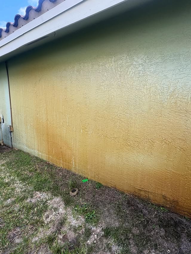 Stucco exterior wall heavily stained before soft wash — TitanFlow Exteriors