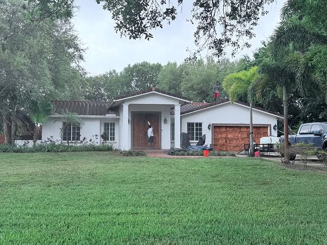 TitanFlow Exteriors crew performing residential house wash — South Florida